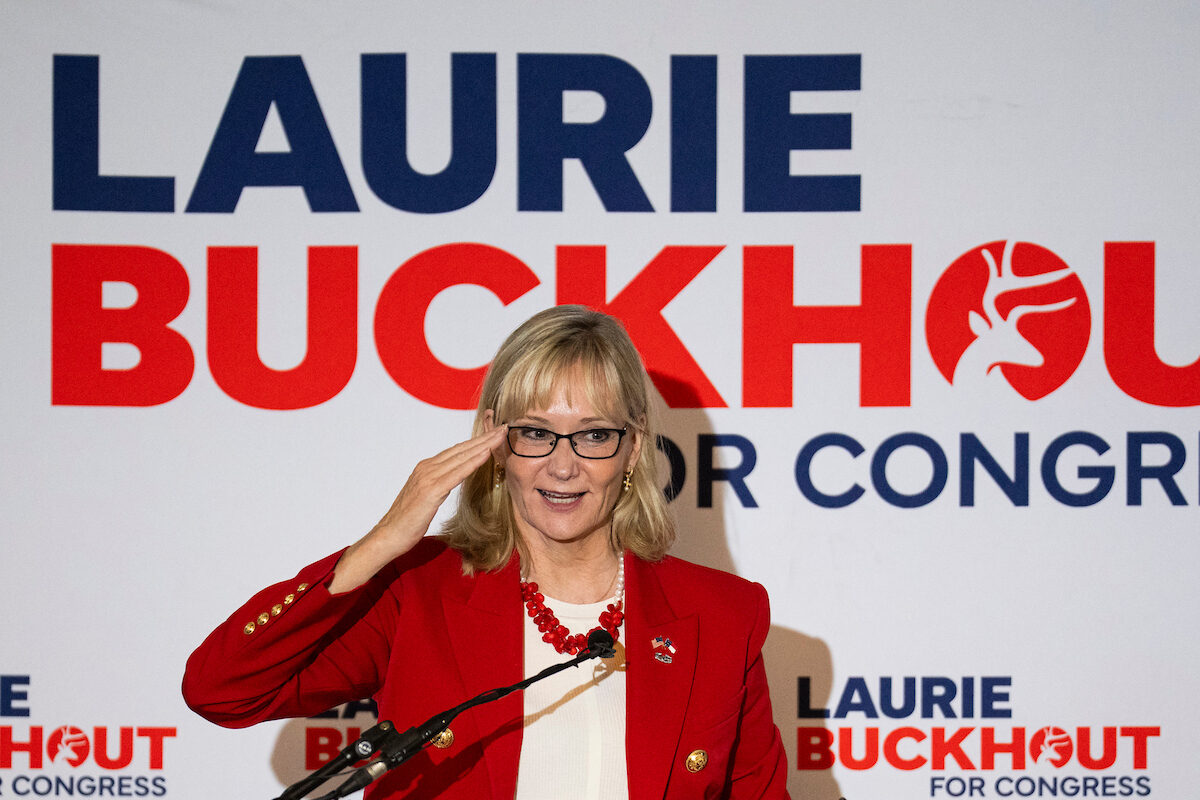 Army veteran Laurie Buckhout, the Republican nominee for North Carolina's 1st District, salutes while speaking at a rally Thursday in New Bern, N.C. (Bill Clark/CQ Roll Call)