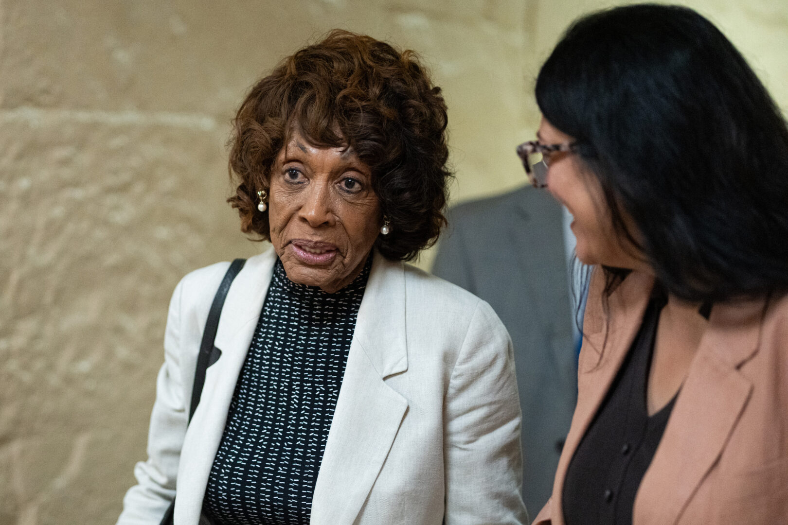 Rep. Maxine Waters, D-Calif., left, talks with Rep. Rashida Tlaib, D-Mich., as they leave a caucus meeting in the Capitol on Sept. 1. (Bill Clark/CQ Roll Call)