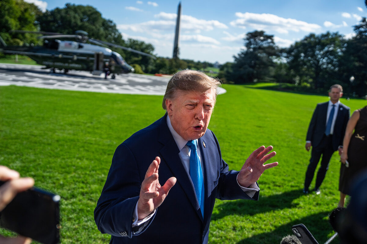 President Donald Trump speaks with reporters on the South Lawn of the White House before boarding Marine One en route to a campaign rally in Nebraska on Oct. 5. (Tom Williams/CQ Roll Call)